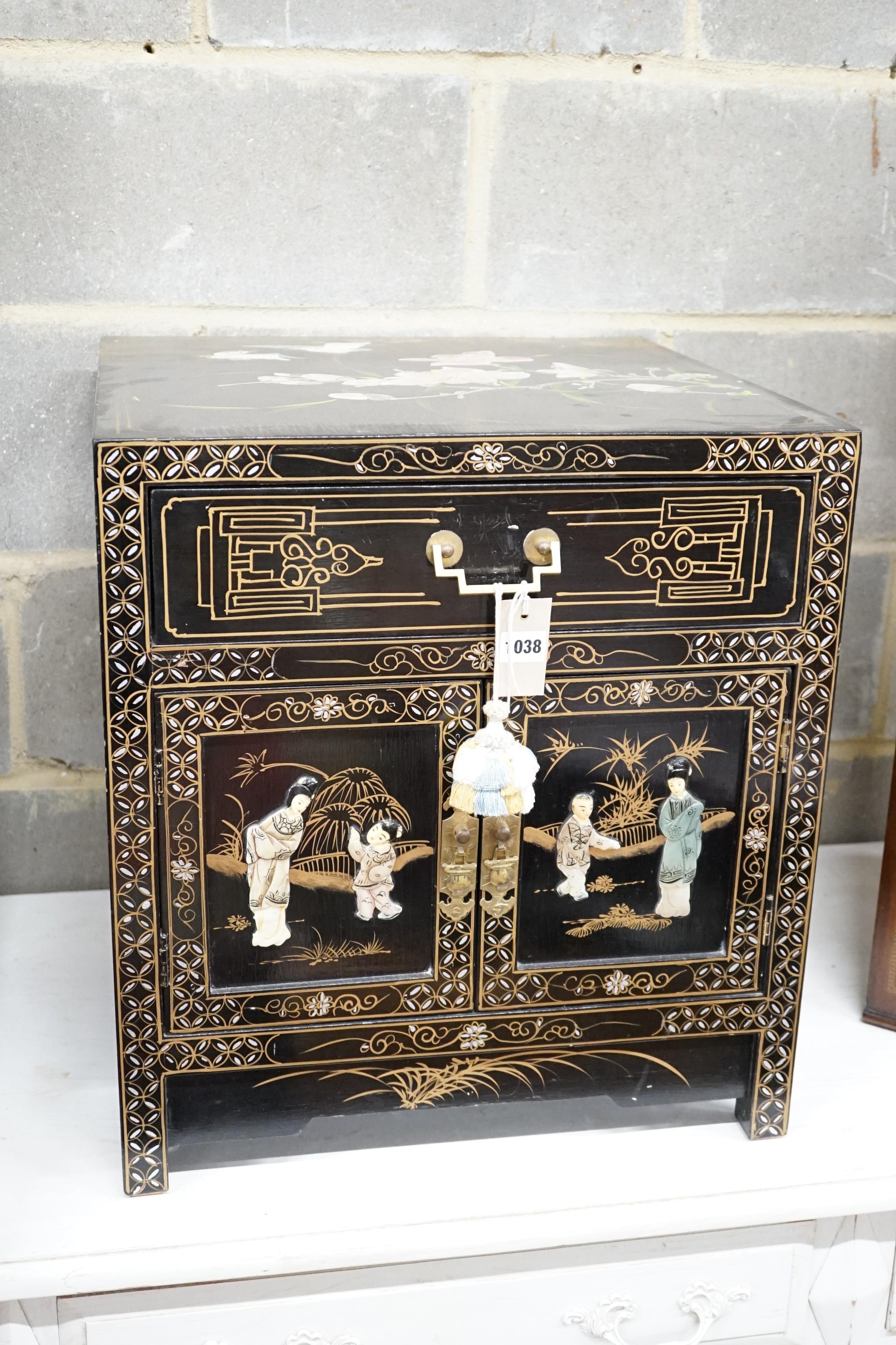 A Chinese black-lacquered brass-mounted small two-door cabinet, the door panels decorated with figures, width 51cm, depth 51cm, height 56cm.